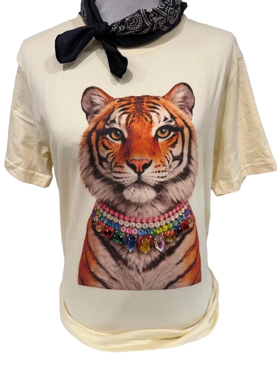 womens offwhite t-shirt with a tiger graphic, with long eye lashes, ans wearing a bejewled crystal colorful necklace