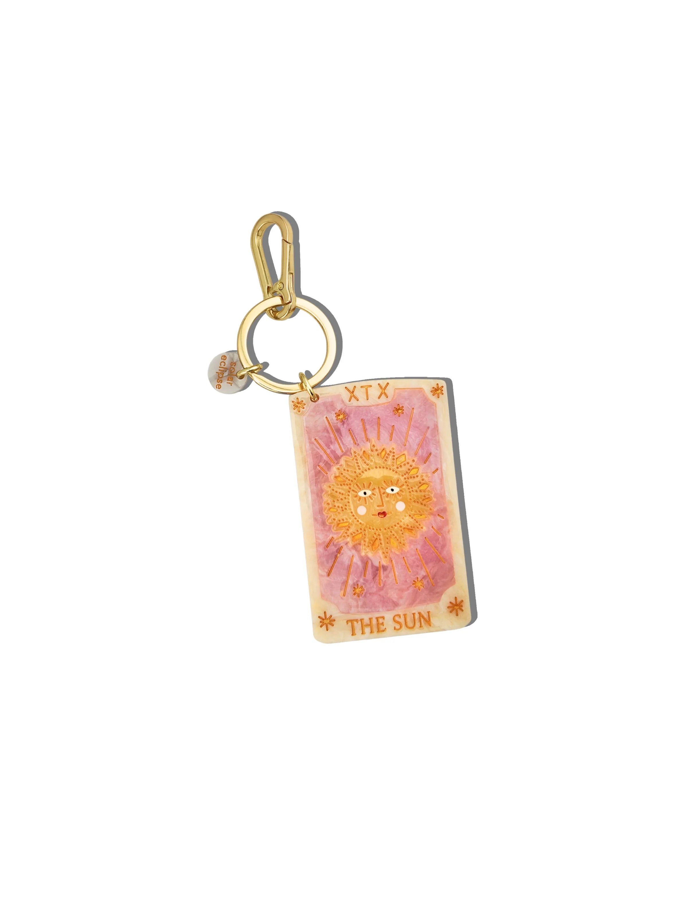 Keychain with tarot card design featuring a sun illustration on a white background