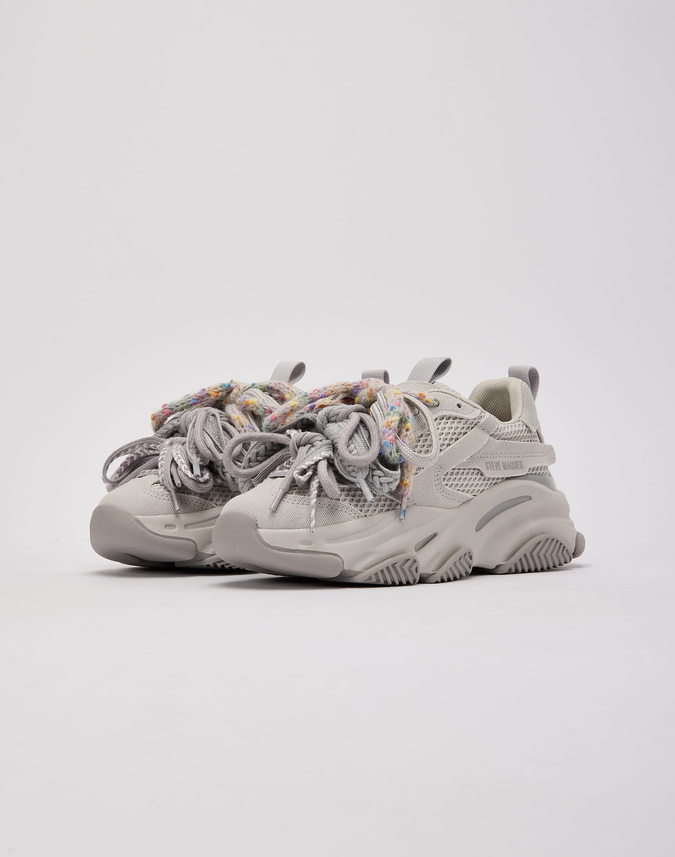 Pair of light gray platform sneakers with colorful laces 